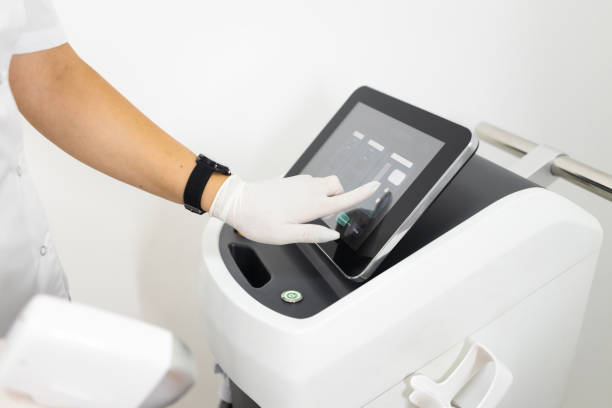 istock The epilation master sets up the laser device before the procedure 1345532016