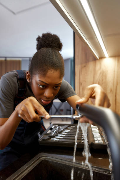 istock Skilful African girl focused on leakage fixing 1345532436