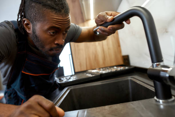 istock Closeup portrait African plumber holding kitchen tap 1345533116