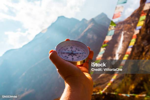 Compass In Hand On The Background Of Blurred Mountain And Prayer Buddhist Flags Stock Photo - Download Image Now