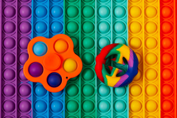 istock Silicone toys (snapperz and simple dimple) on sensory surface Pop it. Push pop fidget toy 1345534488
