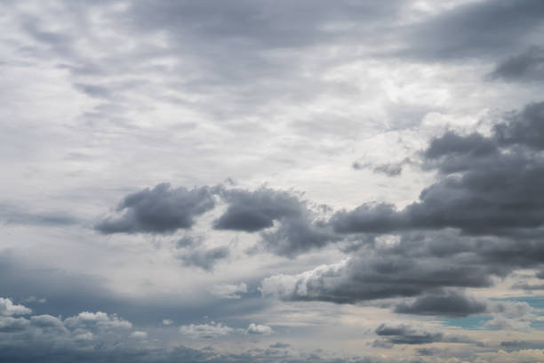 istock Replacement sky background or backdrop with darker white cumulus clouds below and altostratus clouds above in a dramatic blue sky. 1345534527