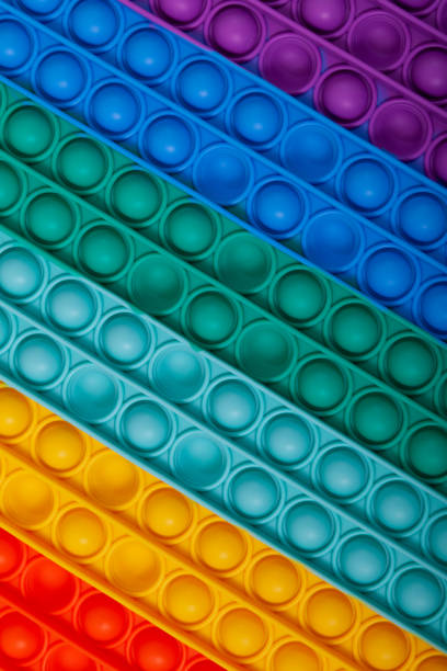 istock Surface of multi-colored rubber children's toy POP IT, close-up. Tap on bubble, finger game. Popular silicone colorful anti stress toy 1345534746