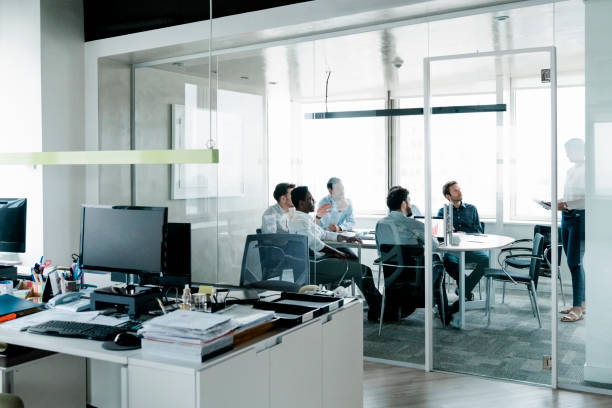 istock Group of office staff having meeting inside boardroom 1345535780