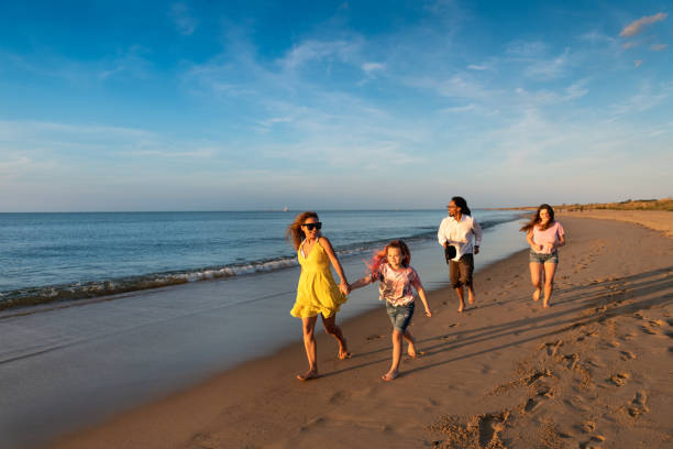 istock Family running by the beach shore 1345536074