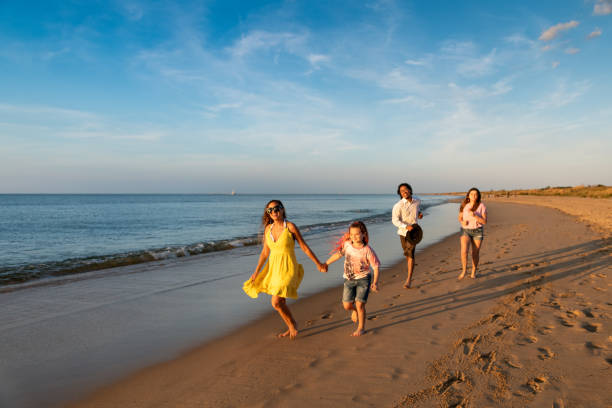 istock Family running by the beach shore 1345536079