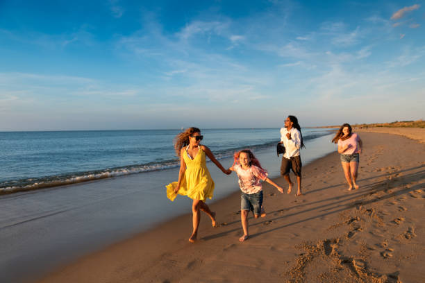 istock Family running by the beach shore 1345536161
