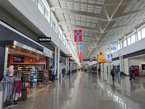 Virginia, USA - August 16, 2021: Empty main concourse and duty free stores inside the Dulles International Airport, IAD, serving Washington, DC, due to corona virus pandemic travel restrictions.