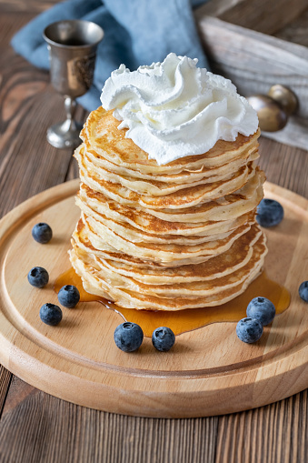 Pancakes with whipped cream and fresh blueberries