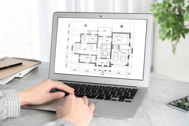 istock Architect making project of house on laptop in office, closeup 1345538418