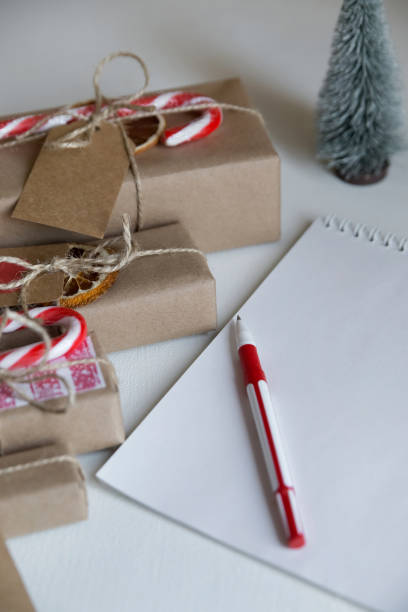 istock Notepad, coffee, christmas gifts, sweets on a light background 1345538429