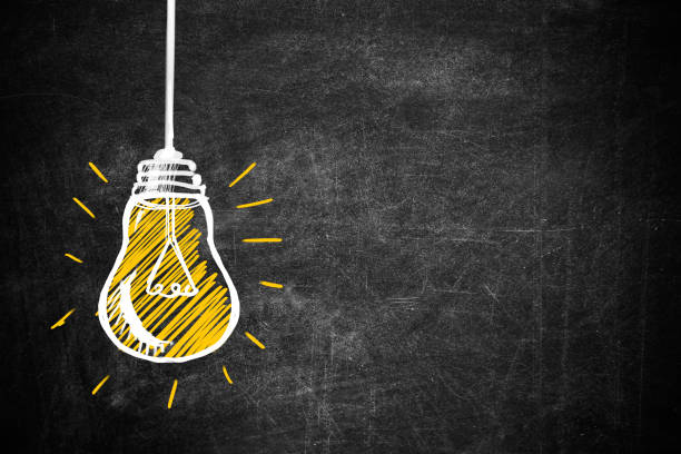 istock Light bulb drawing as symbol of idea on chalkboard 1345538592