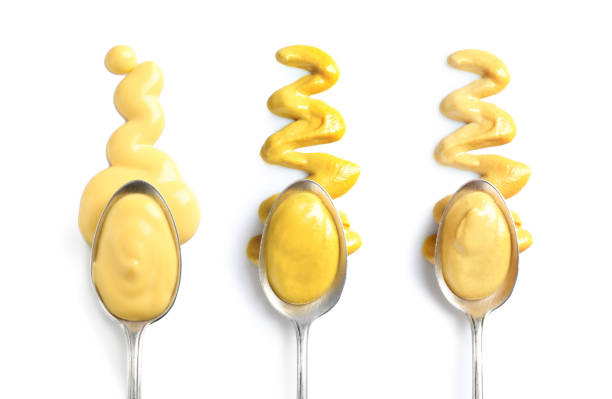 istock Set of spoons with different delicious sauces on white background, top view 1345538907