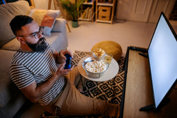 istock Concentrated man having fun with video games 1345539793