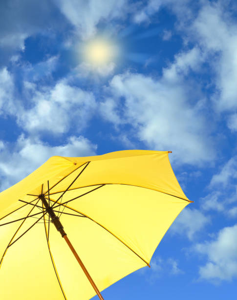 istock Modern yellow umbrella against blue sky. Sun protection 1345539938