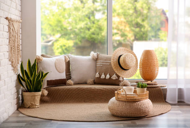 istock Comfortable place for rest with cushions near window indoors 1345539956