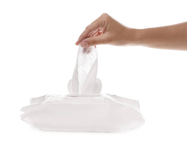 istock Woman taking wet wipe from pack on white background, closeup 1345540013