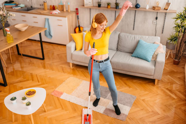 istock Cheerfully woman cleaning house and singing 1345540071