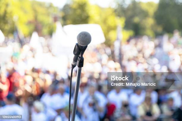 Protest Or Public Demonstration Focus On Microphone Blurred Crowd Of People In The Background Stock Photo - Download Image Now