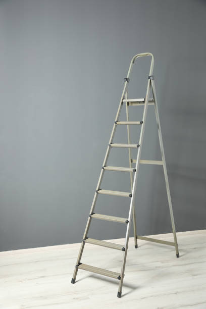 istock Modern metal step ladder near grey wall 1345540475
