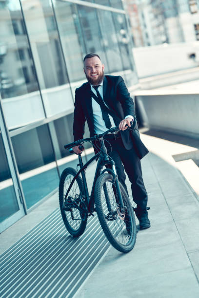 istock Handsome Businessman Ready To Go Home With Bicycle After Work 1345541480