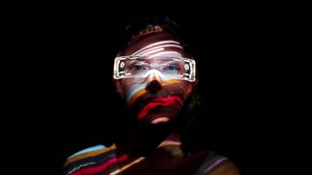 Projection on a woman's face wearing futuristic glasses
