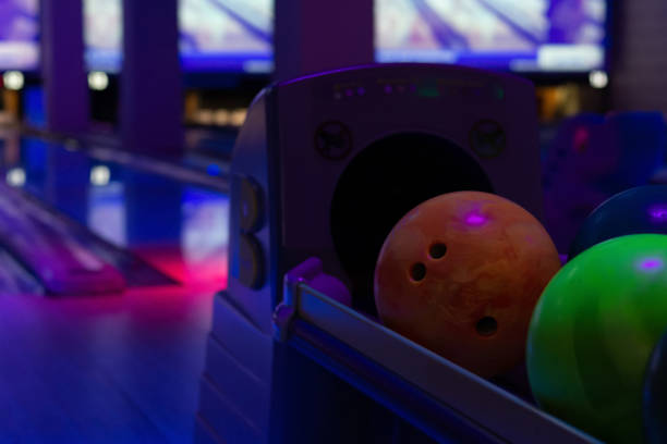 colorful bowling balls colorful bowling balls on a stand in a bowling club bowling alley wood stock pictures, royalty-free photos & images