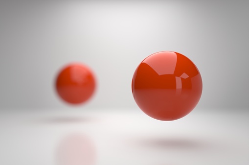 Two red sphere and focus on foreground three dimensional.