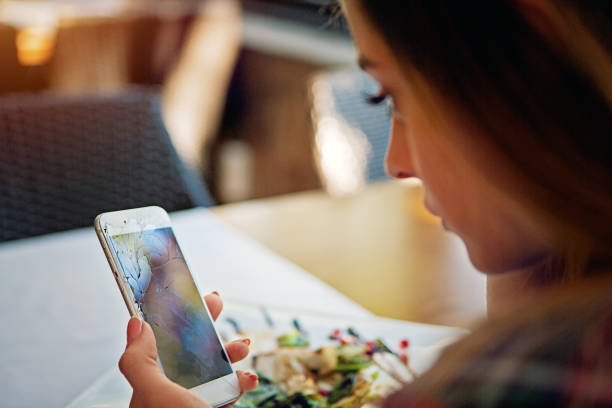 istock Sad young woman is holding her broken mobile phone 1345545908
