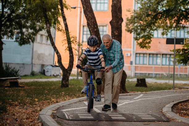 istock Child learning to ride bike 1345546583