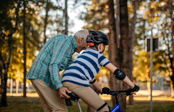 istock Child learning to ride bike 1345546584