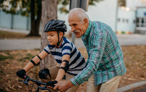 istock Child learning to ride bike 1345546586