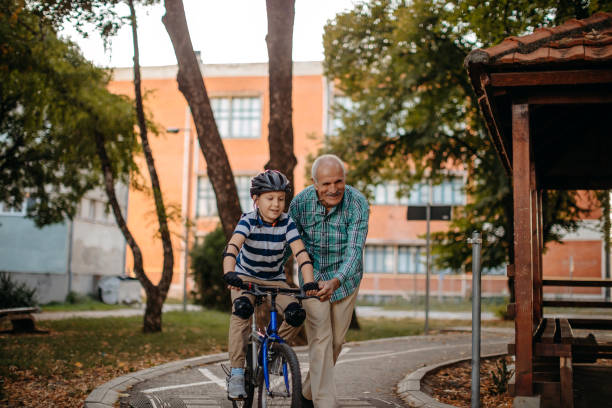 istock Child learning to ride bike 1345546606
