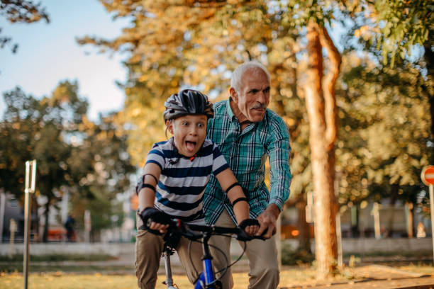 istock Child learning to ride bike 1345546646
