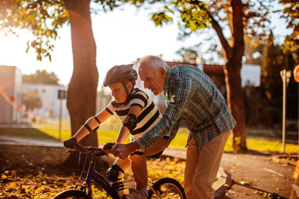 istock Child learning to ride bike 1345546691