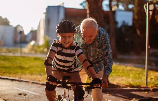 istock Child learning to ride bike 1345546718