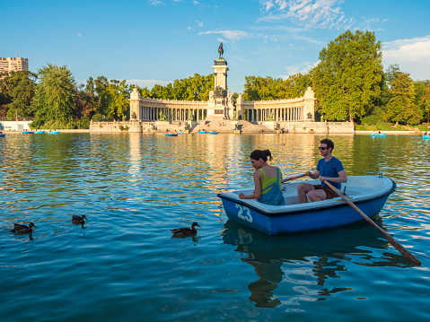 Madrid, Spain. 08/04/2021.   People of all ages have fun boating with the ducks at the pond in Madrid's Buen Retiro Park.