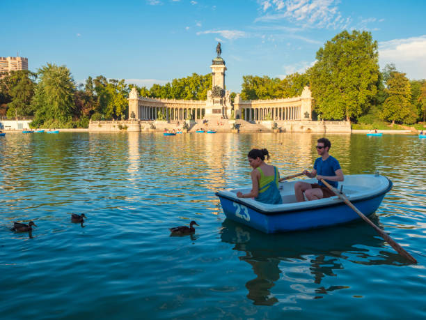 Boat trips in the Retiro pond Madrid, Spain. 08/04/2021.   People of all ages have fun boating with the ducks at the pond in Madrid's Buen Retiro Park. couple punting stock pictures, royalty-free photos & images