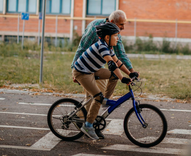 istock Child learning to ride bike 1345546809