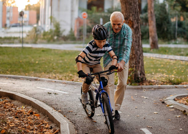 istock Child learning to ride bike 1345546845