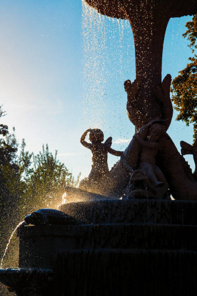 Silhouette of a statue from the fountain of madrid's Buen Retiro Park at sunset