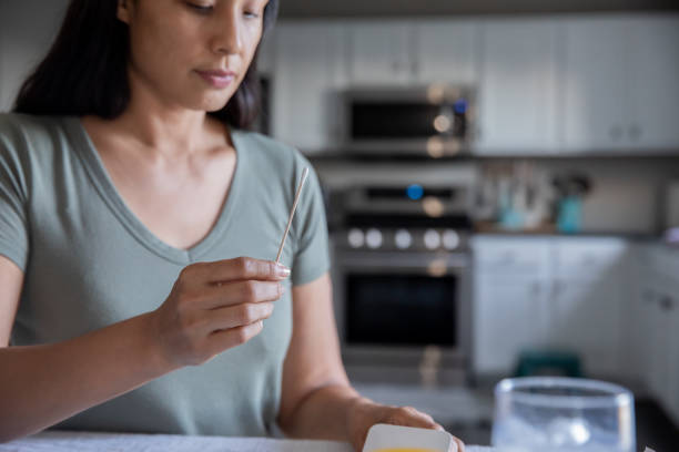 istock Serious Woman self testing for Covid-19 1345547991