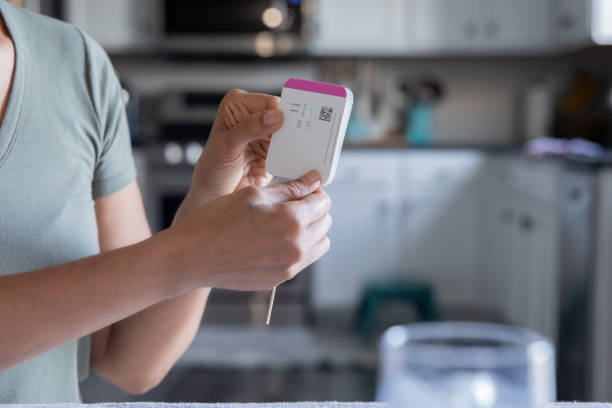 istock Woman Holding Medical testing tool for covid-19 1345547994