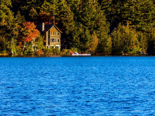 istock Large lake with a house in the background (Lake Placid) 1345549436