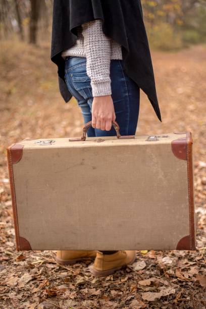 istock Woman walking alone in the forest 1345549683