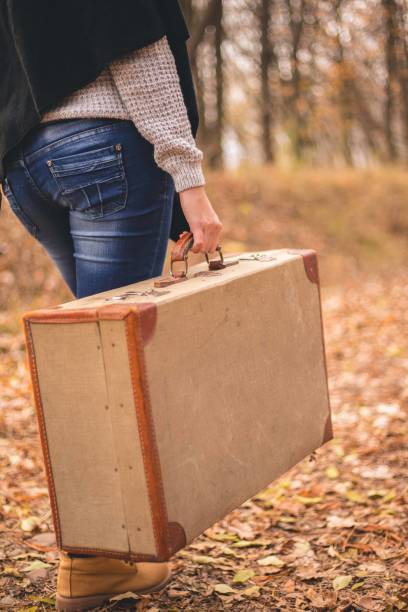 istock Woman walking alone in the forest 1345549739