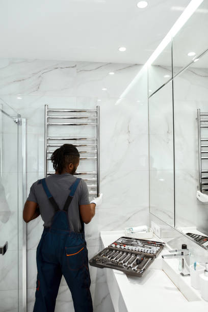 istock Young plumber installing electric towel rail in modern bathroom 1345551328