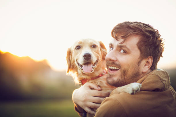 istock Guy and his dog, golden retriever, nature 1345551380