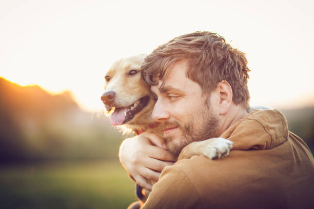 istock Guy and his dog, golden retriever, nature 1345551381