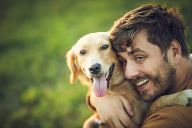 istock Guy and his dog, golden retriever, nature 1345552130